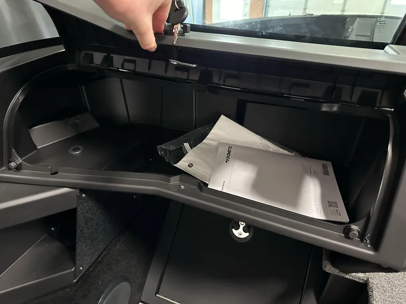 Slide: The Image of 2025 Alumacraft Competitor 205X Sport glove compartment with documents inside. - 14