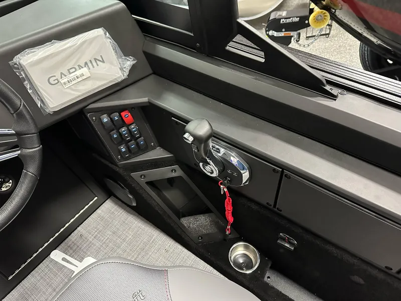 Slide: The Image of 2025 Alumacraft Competitor 205X Sport boat interior with control panel and steering wheel. - 17