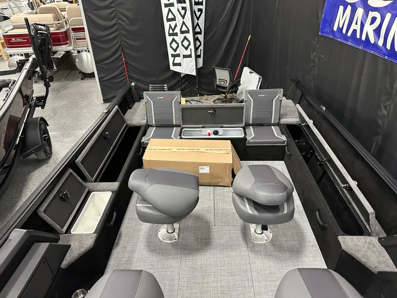 Slide: The Image of 2025 Alumacraft Competitor 205X Sport boat interior with seating and storage compartments. - 19