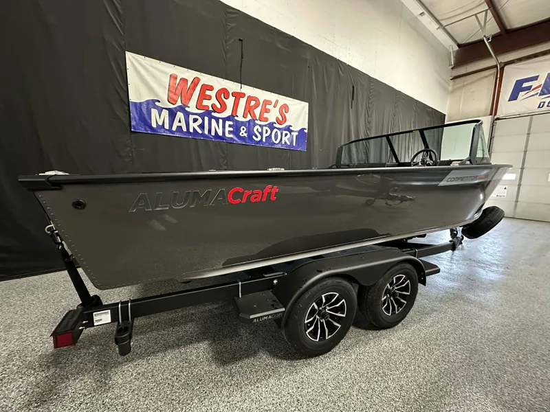 Slide: The Image of 2025 Alumacraft Competitor 205X Sport boat on trailer at Westre's Marine & Sport showroom. - 2