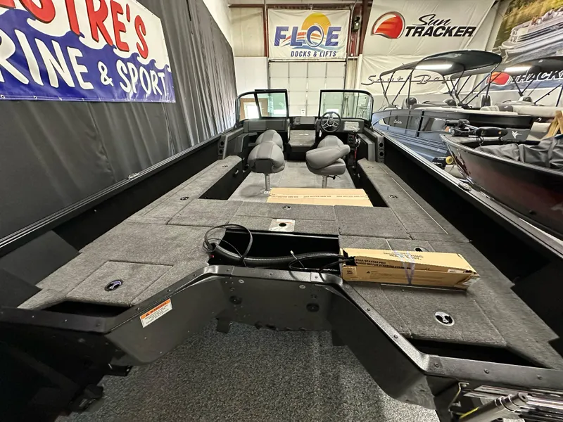 Slide: The Image of 2025 Alumacraft Competitor 205X Sport boat interior, featuring spacious seating and storage areas. - 21