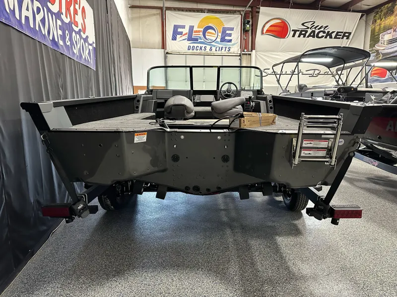 Slide: The Image of 2025 Alumacraft Competitor 205X Sport boat displayed indoors, rear view with ladder and seats. - 3