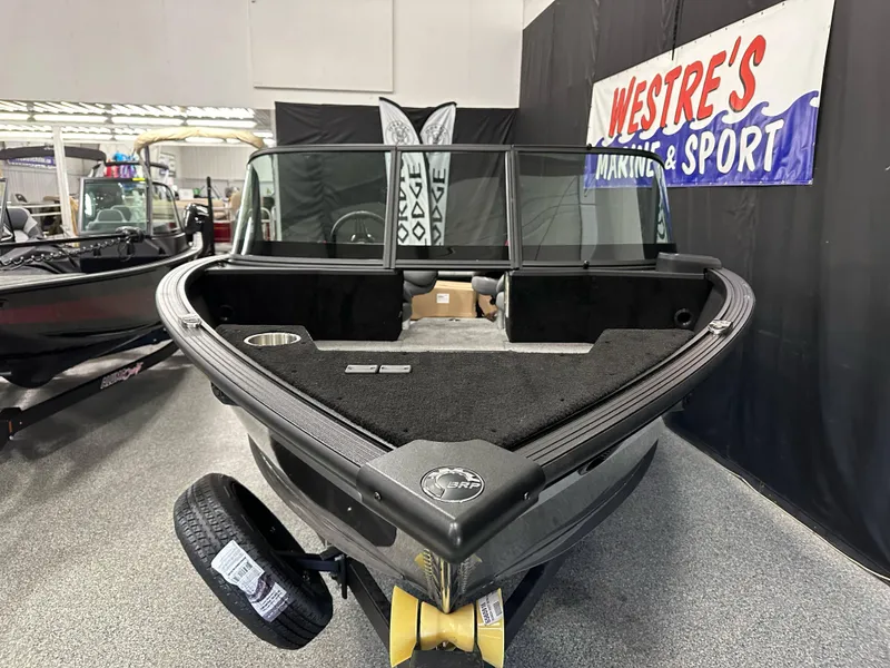 Slide: The Image of 2025 Alumacraft Competitor 205X Sport boat displayed indoors at Westre's Marine & Sport. - 4