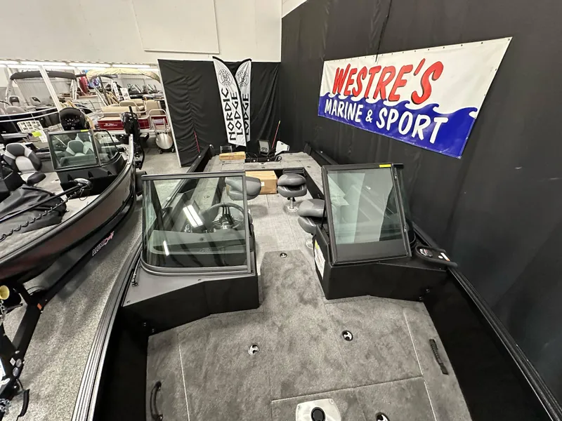 Slide: The Image of 2025 Alumacraft Competitor 205X Sport boat displayed at Westre's Marine & Sport showroom. - 6