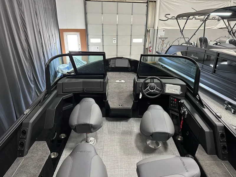 Slide: The Image of 2025 Alumacraft Competitor 205X Sport boat interior with seating and steering console. - 9