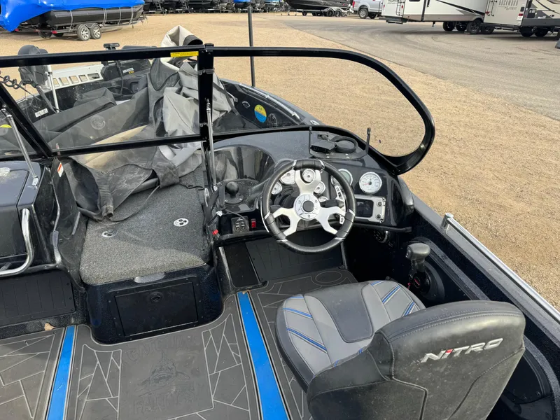 Slide: The Image of 2022 Nitro ZV21 boat interior with steering wheel and seating. - 10