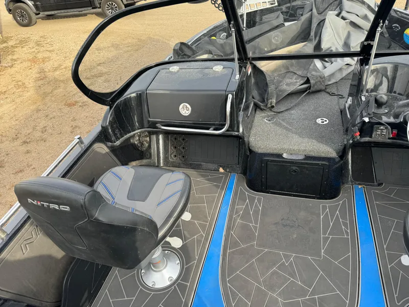 Slide: The Image of 2022 Nitro ZV21 boat interior with seating and dashboard, featuring modern design and blue accents. - 11