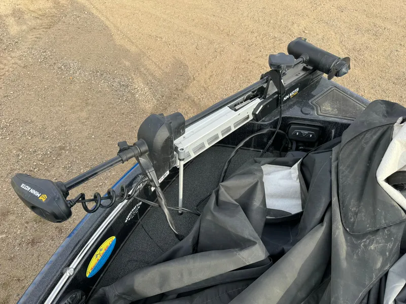 Slide: The Image of Nitro ZV21 boat with Minn Kota trolling motor, 2022 model, on a sandy surface. - 14