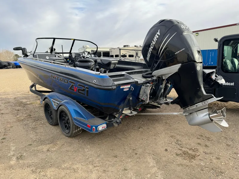 Slide: The Image of 2022 Nitro ZV21 boat with Mercury engine on trailer, parked outdoors. - 3