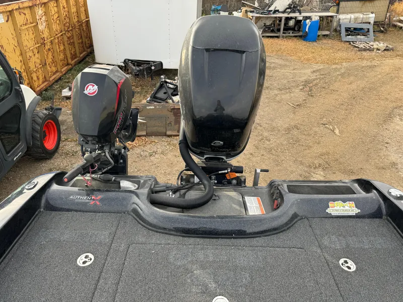 Slide: The Image of 2022 Nitro ZV21 boat with dual outboard motors in a yard setting. - 7