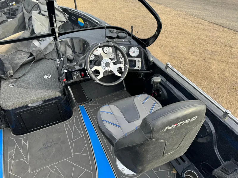 Slide: The Image of Interior of a 2022 Nitro ZV21 boat with steering wheel and seating. - 8