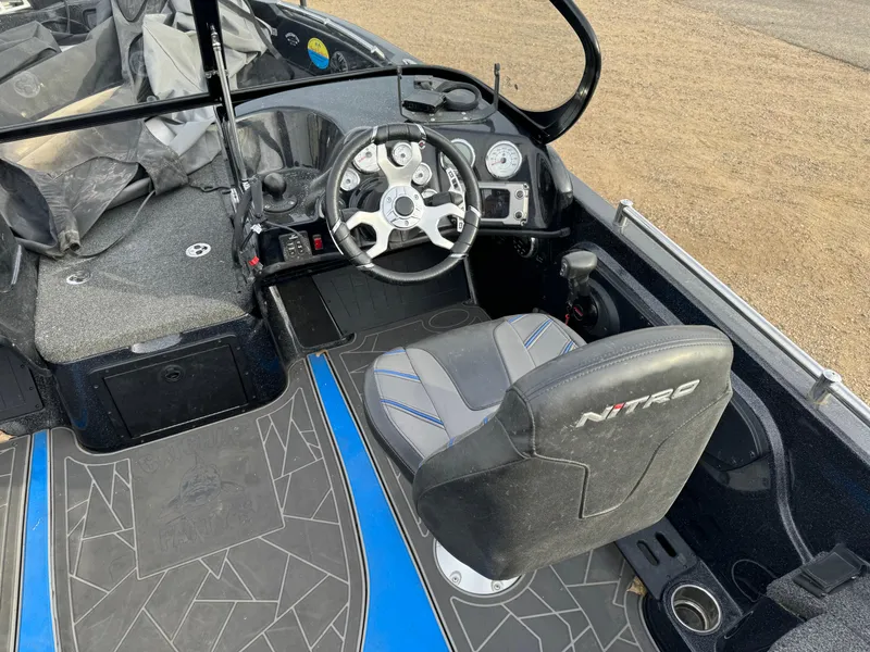 Slide: The Image of 2022 Nitro ZV21 boat interior with steering wheel and captain's seat. - 9