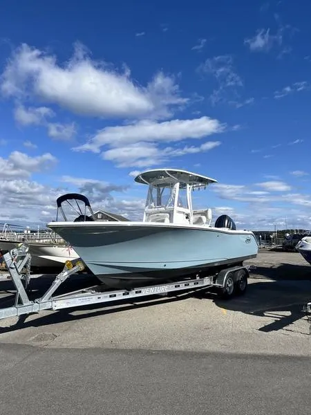 Slide: The Image of 2024 Sea Hunt Ultra 229 boat on trailer under blue sky. - 2