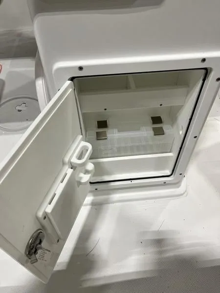 Slide: The Image of 2024 Sea Hunt Ultra 229 storage compartment with open door, showcasing interior space. - 6