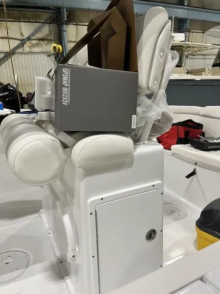 Slide: The Image of 2024 Sea Hunt Ultra 229 boat interior with white seating and storage compartment. - 7