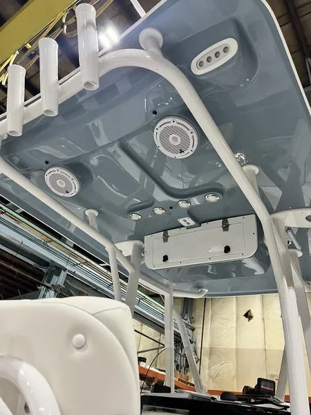 Slide: The Image of 2024 Sea Hunt Ultra 229 boat with modern overhead features and speakers. - 9