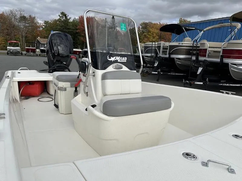 Slide: The Image of 2023 Mako SKIFF 17 CC boat with center console and seating, displayed outdoors. - 10