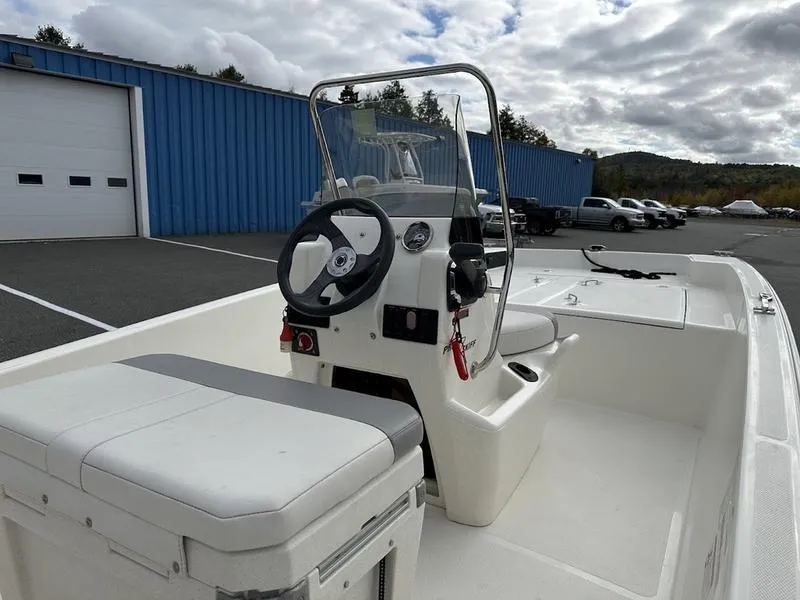 Slide: The Image of 2023 Mako SKIFF 17 CC boat interior with steering console and seating. - 4