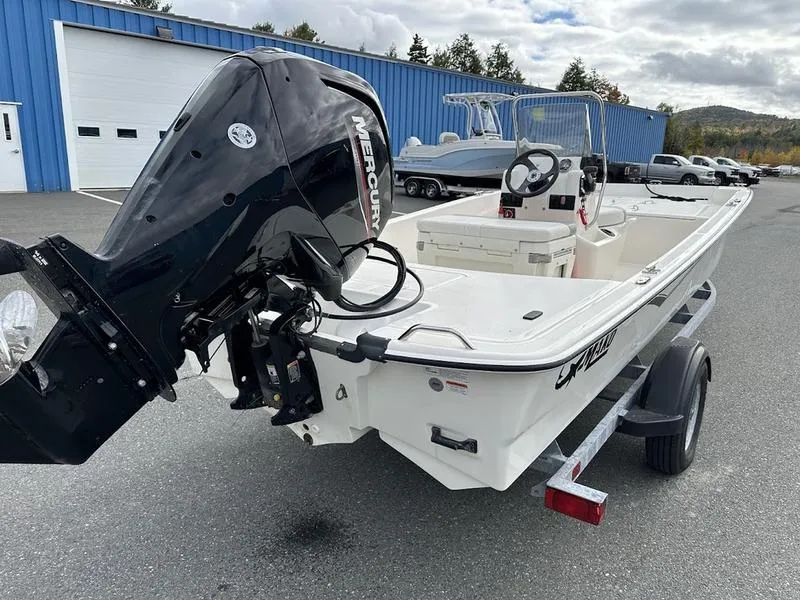 Slide: The Image of 2023 Mako SKIFF 17 CC boat with Mercury engine on trailer, parked outdoors. - 5
