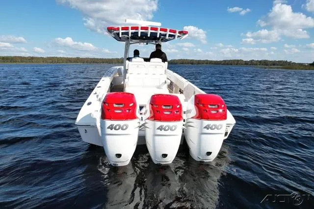 Slide: The Image of 2023 Fountain 34 CC boat with triple 400 horsepower engines on a lake. - 10