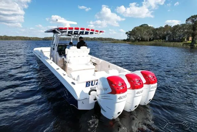 Slide: The Image of 2023 Fountain 34 CC boat with triple 400 horsepower engines on a lake. - 11