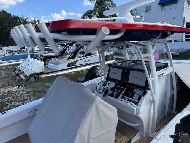 Slide: The Image of 2023 Fountain 34 CC boat with advanced navigation system docked at marina. - 19