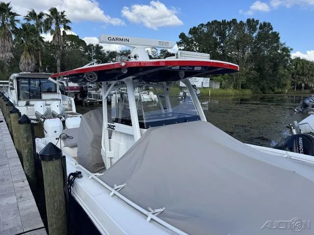 Slide: The Image of 2023 Fountain 34 CC boat docked with cover, featuring Garmin radar. - 22