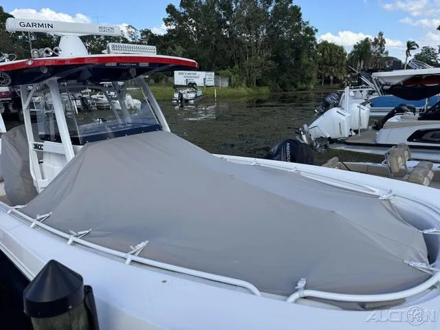 Slide: The Image of 2023 Fountain 34 CC boat with cover docked at marina. - 23