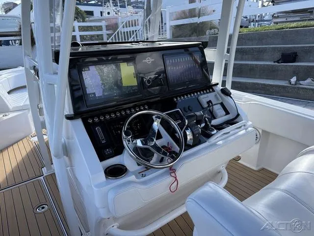 Slide: The Image of 2023 Fountain 34 CC boat dashboard with advanced navigation system and controls. - 26