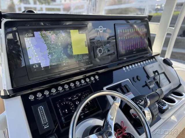 Slide: The Image of 2023 Fountain 34 CC boat dashboard with navigation screens and controls. - 27