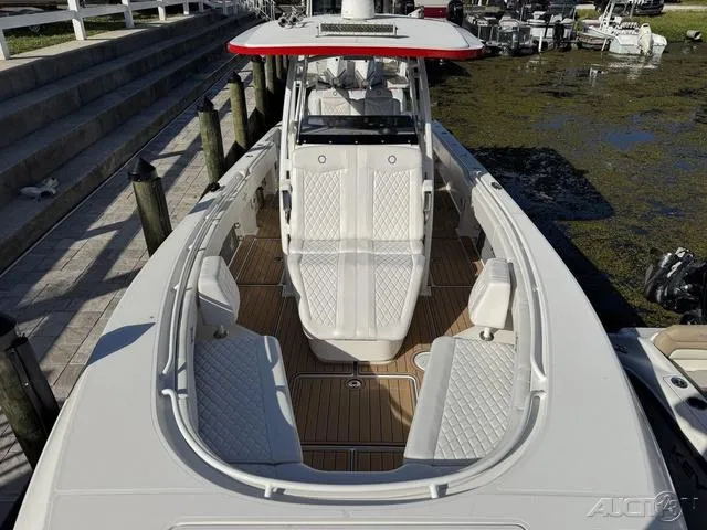 Slide: The Image of 2023 Fountain 34 CC boat with sleek design and spacious seating at the dock. - 31