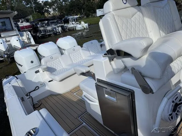 Slide: The Image of 2023 Fountain 34 CC boat interior with luxurious white seating and Mercury engines. - 39