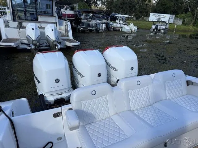 Slide: The Image of 2023 Fountain 34 CC boat with triple Mercury outboard engines and white seating. - 41