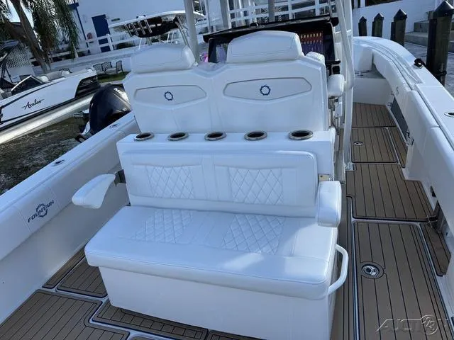 Slide: The Image of 2023 Fountain 34 CC boat interior with white seating and cup holders. - 42