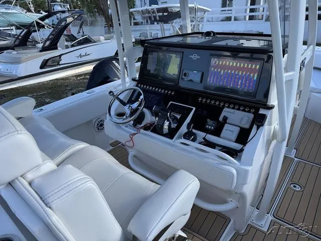 Slide: The Image of 2023 Fountain 34 CC boat dashboard with advanced navigation and control systems. - 45