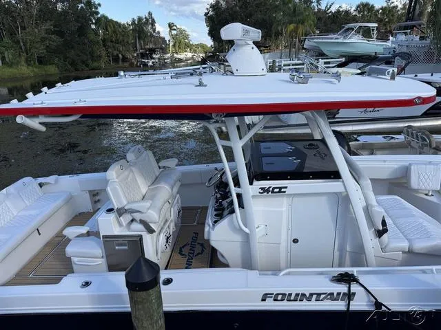 Slide: The Image of 2023 Fountain 34 CC boat docked, featuring sleek design and spacious seating. - 47