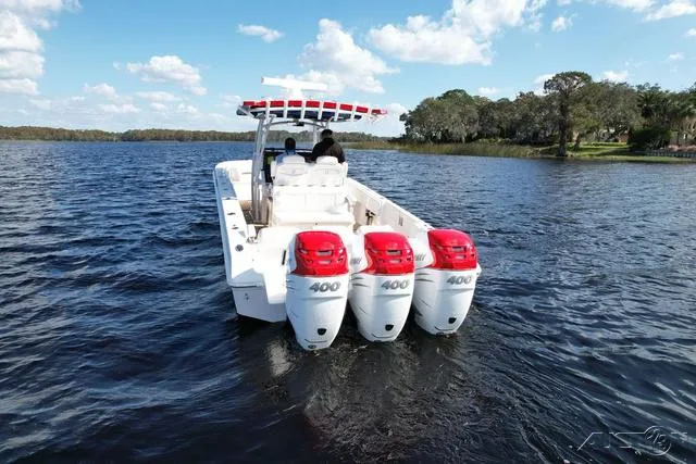 Slide: The Image of 2023 Fountain 34 CC boat with triple 400 horsepower engines on a lake. - 5