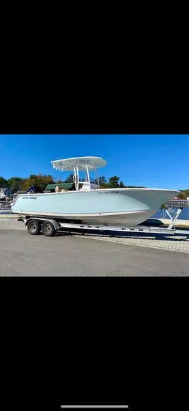 Slide: The Image of 2023 Sportsman 231 Heritage boat on trailer by waterfront. - 0