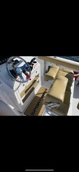Slide: The Image of 2023 Sportsman 231 Heritage boat interior with tan seating and steering console. - 10