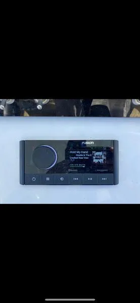 Slide: The Image of Close-up of a 2023 Sportsman 231 Heritage boat stereo system display. - 13