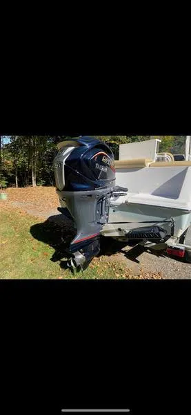 Slide: The Image of 2023 Sportsman 231 Heritage boat with outboard motor in a sunny outdoor setting. - 15