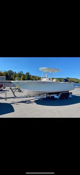 Slide: The Image of 2023 Sportsman 231 Heritage boat on trailer in sunny outdoor setting. - 3