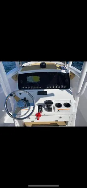 Slide: The Image of 2023 Sportsman 231 Heritage boat dashboard with steering wheel and controls. - 9