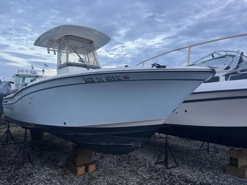 Slide: The Image of 2022 Grady-White 257 Fisherman boat on stands, cloudy sky background. - 13
