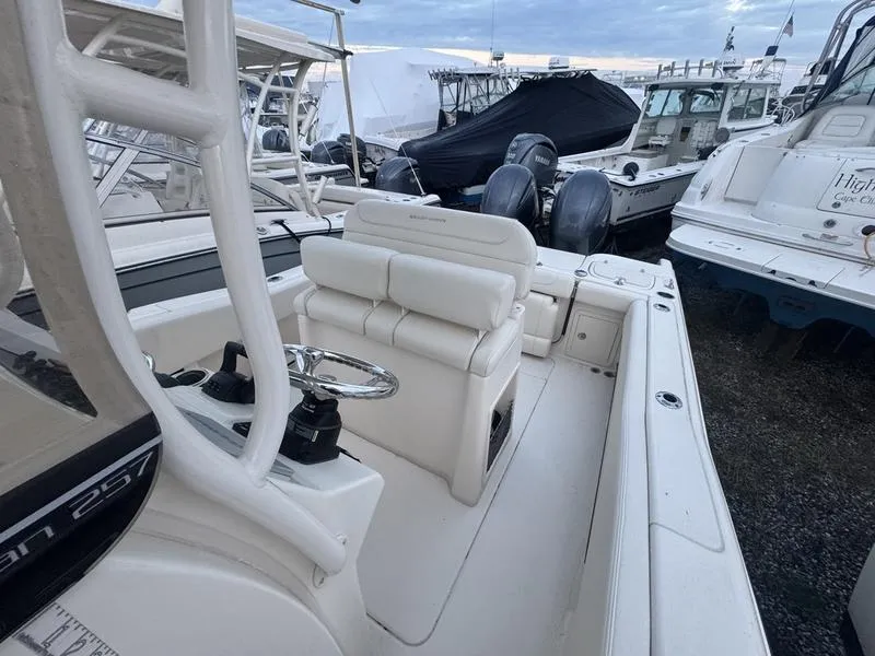 Slide: The Image of 2022 Grady-White 257 Fisherman boat interior with seating and steering wheel. - 14