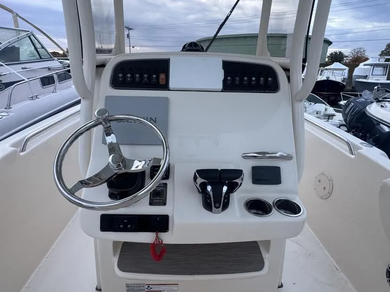 Slide: The Image of 2022 Grady-White 257 Fisherman boat console with steering wheel and controls. - 16