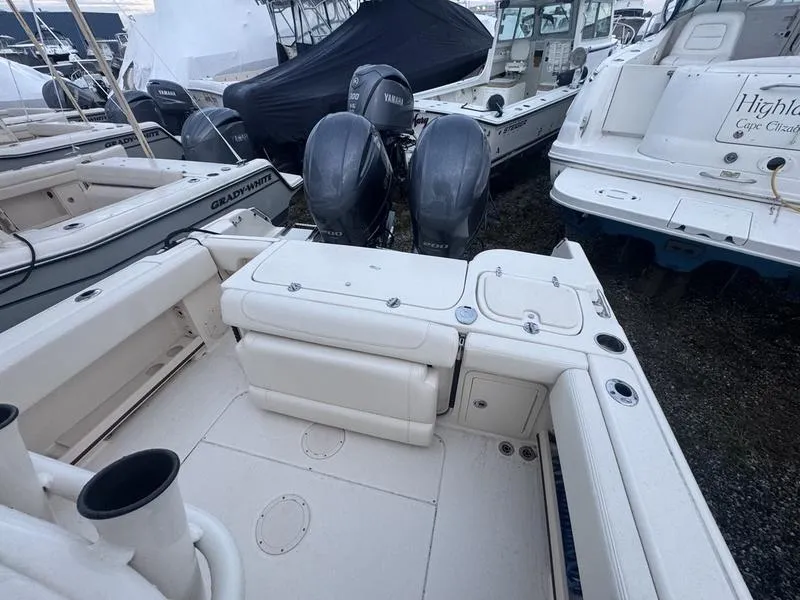 Slide: The Image of 2022 Grady-White 257 Fisherman boat with dual outboard engines in a marina. - 3