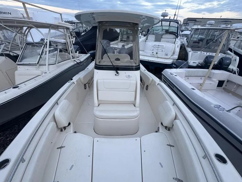 Slide: The Image of 2022 Grady-White 257 Fisherman boat, white interior, docked among other boats. - 5