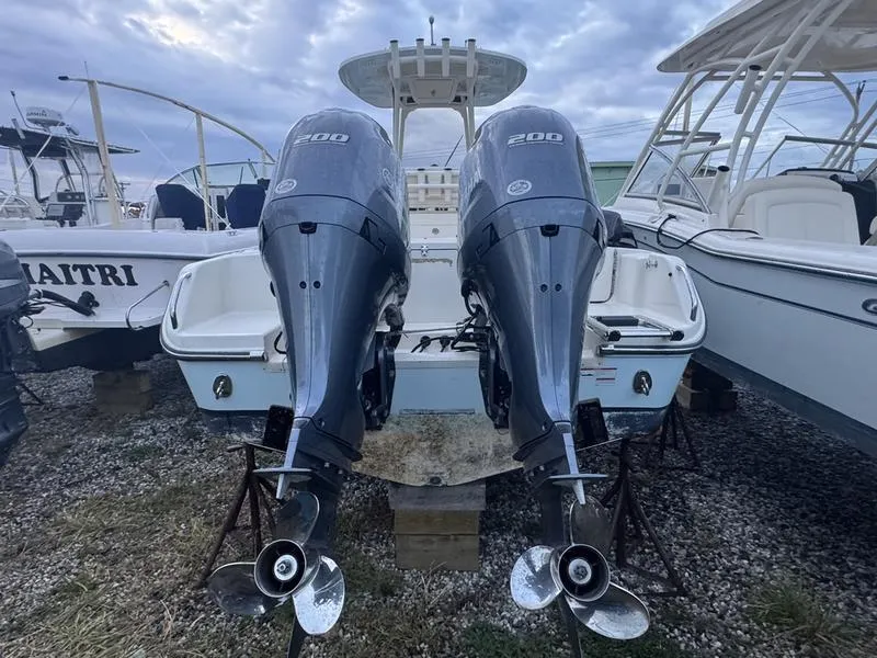 Slide: The Image of 2022 Grady-White 257 Fisherman boat with dual 200 horsepower engines, docked on gravel. - 8