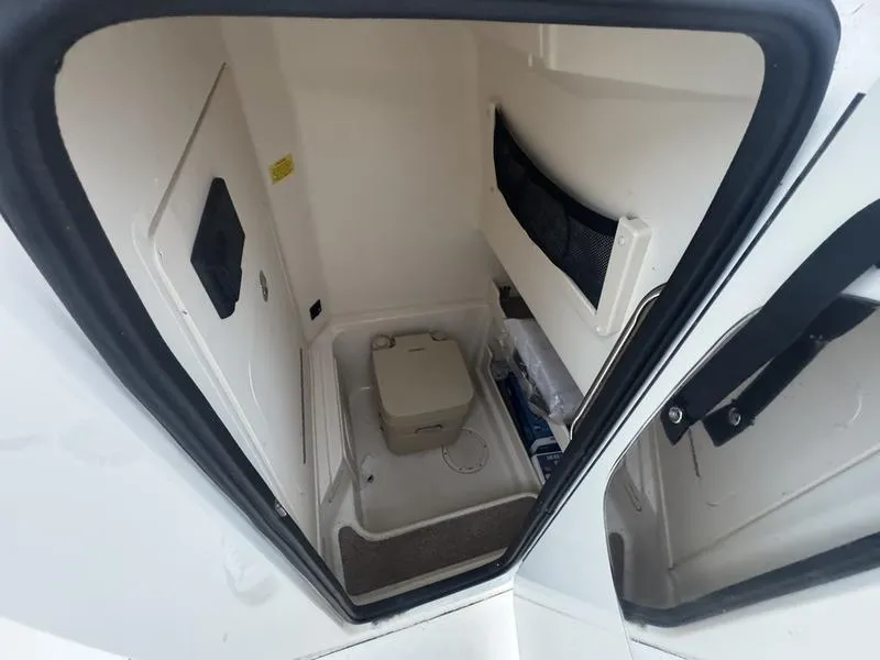 Slide: The Image of 2022 Grady-White 257 Fisherman boat interior with compact toilet and storage area. - 9